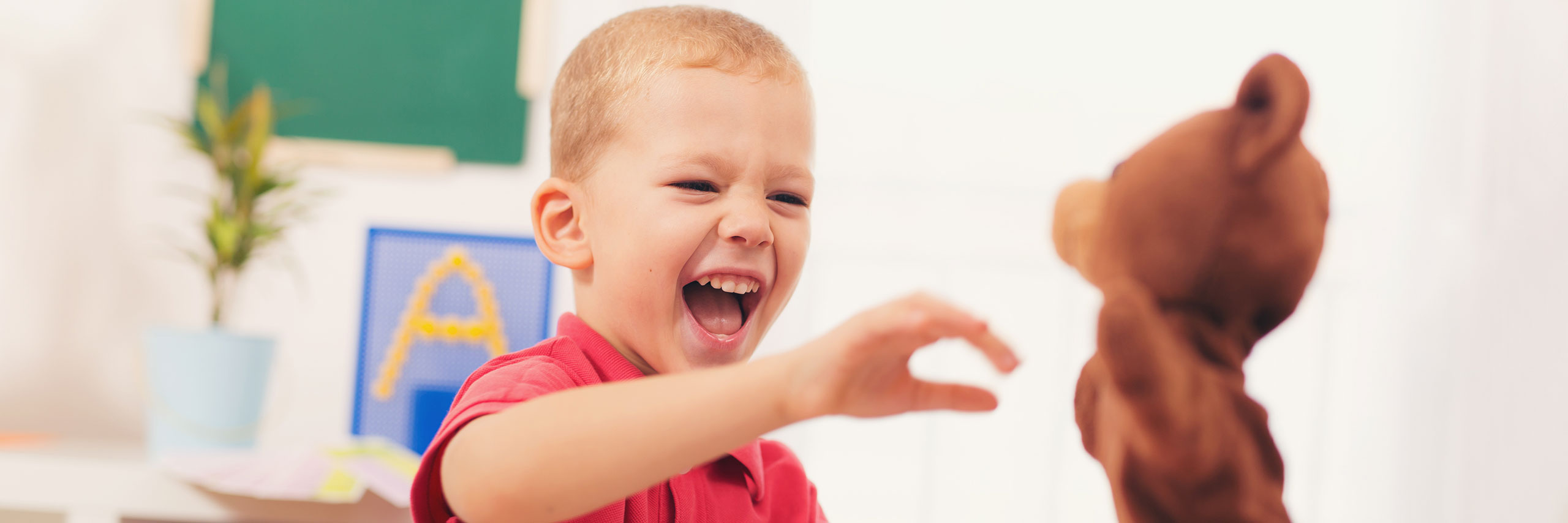 A kid playing with a toy in a clinic room