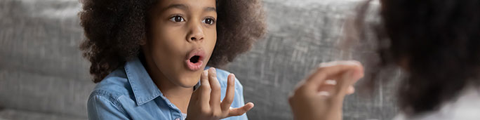 A young girl doing a voice exercise.